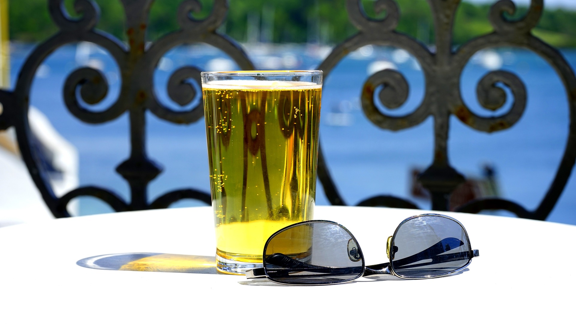 Glass of beer in a tropical scene